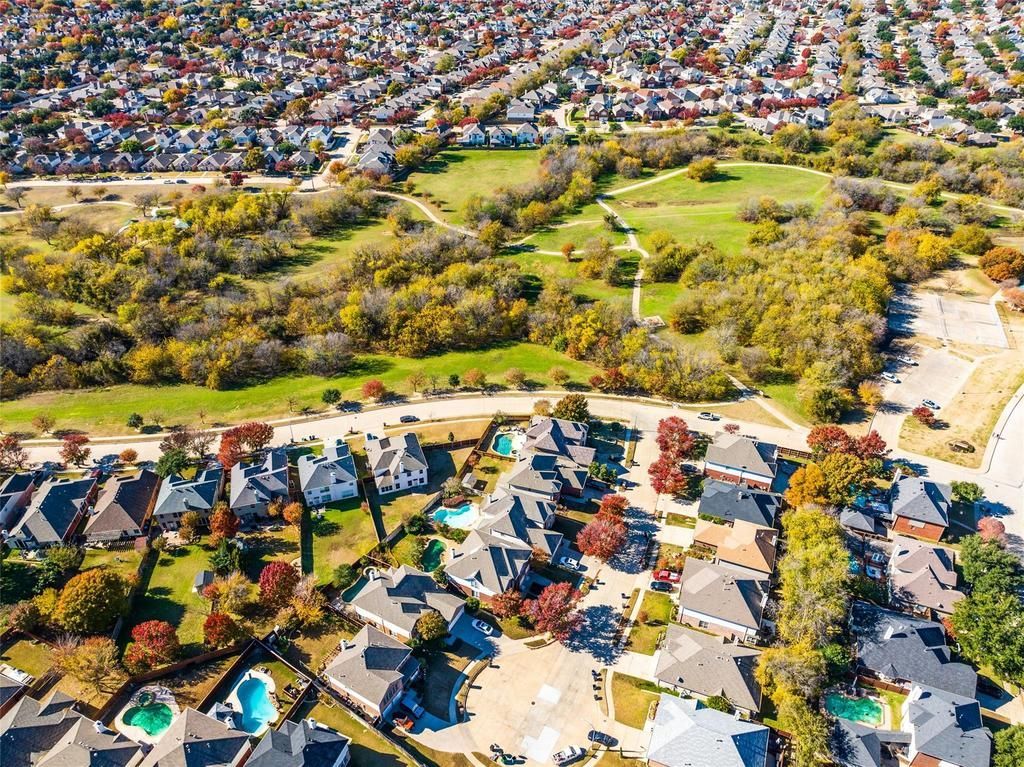 an aerial view of a residential area with lots of houses and trees