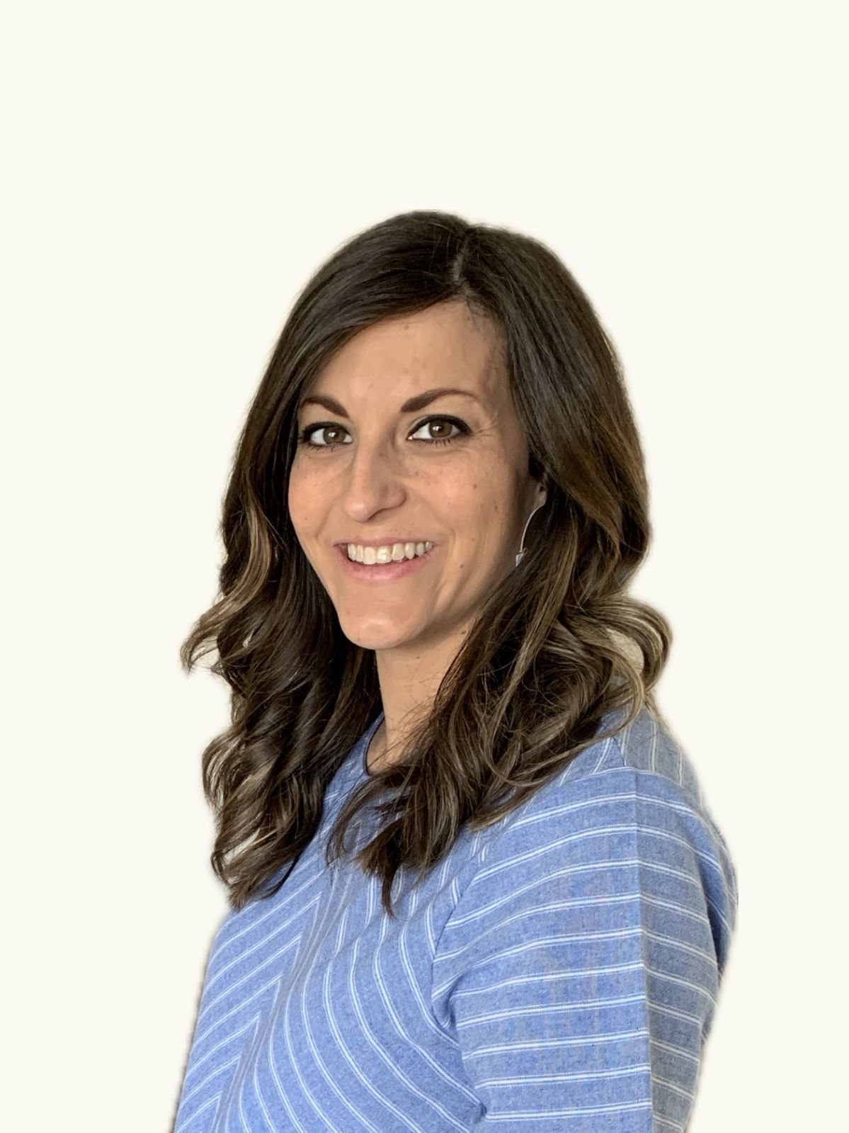 A woman in a blue striped shirt is smiling for the camera.