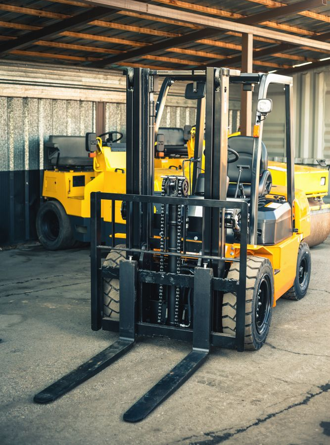 Trench dug in concrete. A pickaxe and shovel lie nearby, with a pile of dirt.