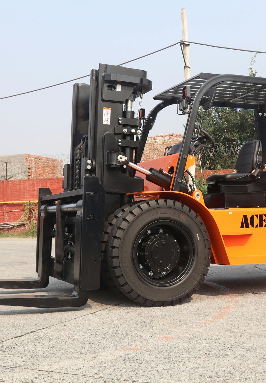Yellow and black forklift on pavement.