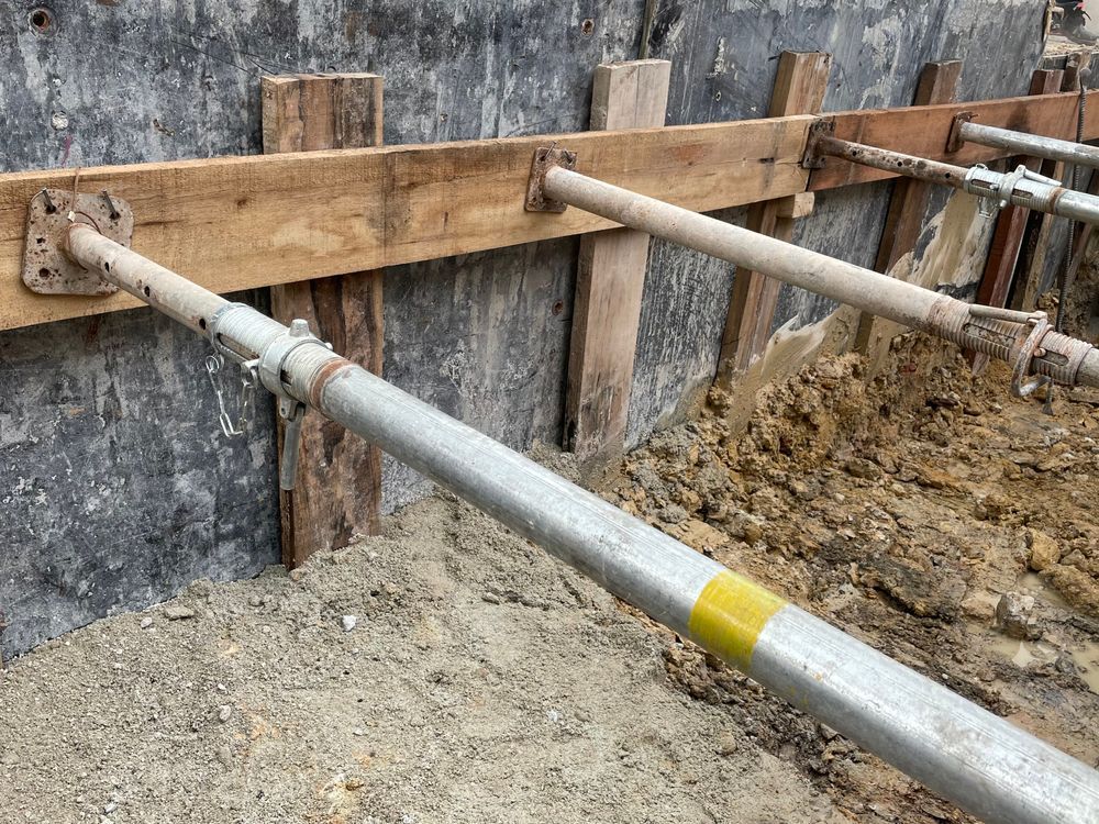 A scaffolding system is being used to build a wall.