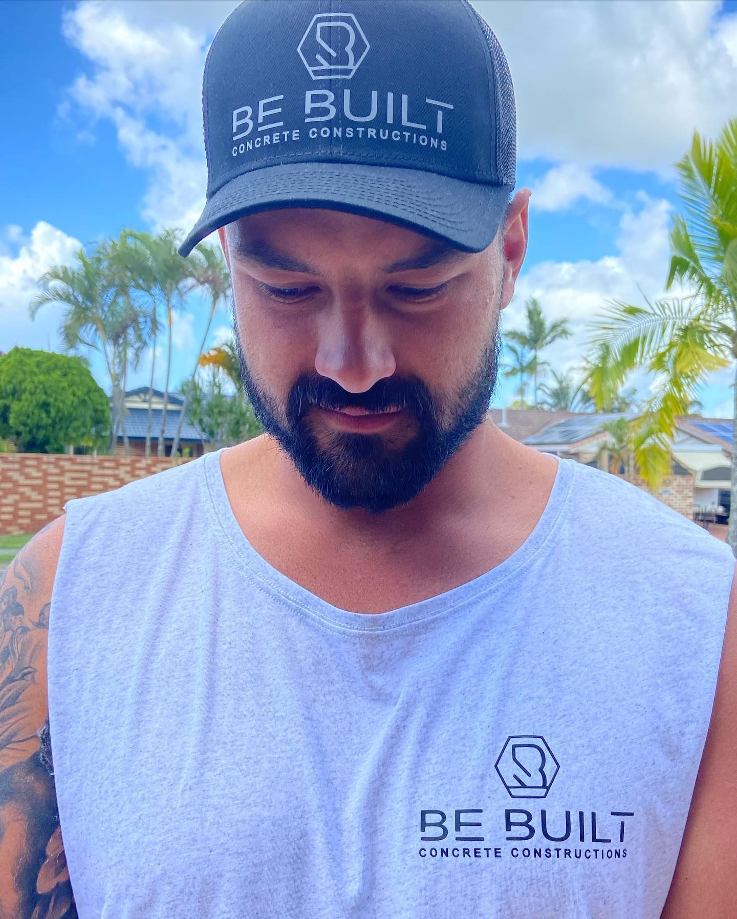 A man wearing a hat that says be built on it