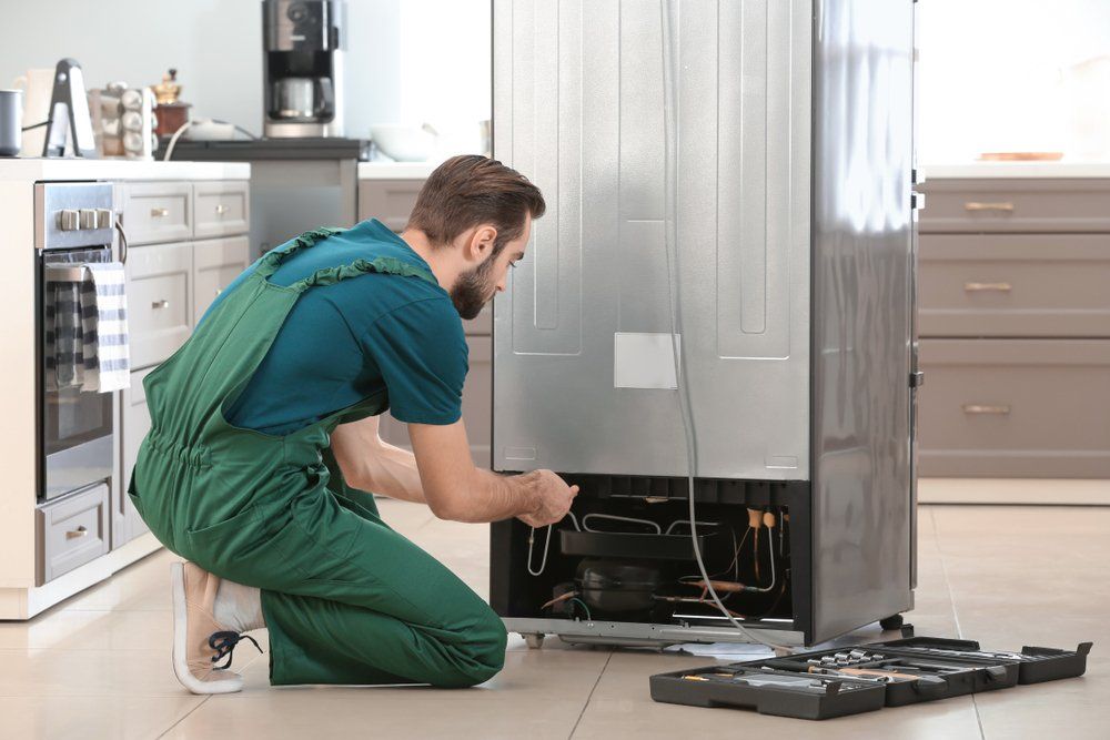 Male Technician Repairing Refrigerator — Refrigeration & Air Conditioning in Lake Macquarie, NSW