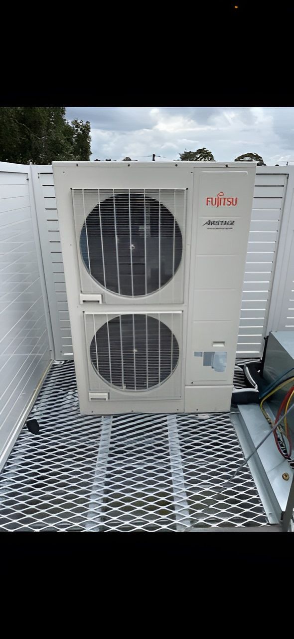 A White Fujitsu Air Conditioning Unit With Two Circular Fan Grates — Refrigeration & Air Conditioning in Jewells, NSW