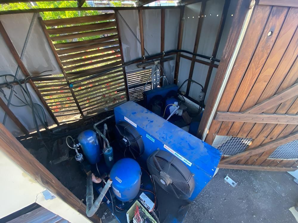 Blue Machinery With Fans, Inside a Wooden Shed — Refrigeration & Air Conditioning in Central Coast, NSW