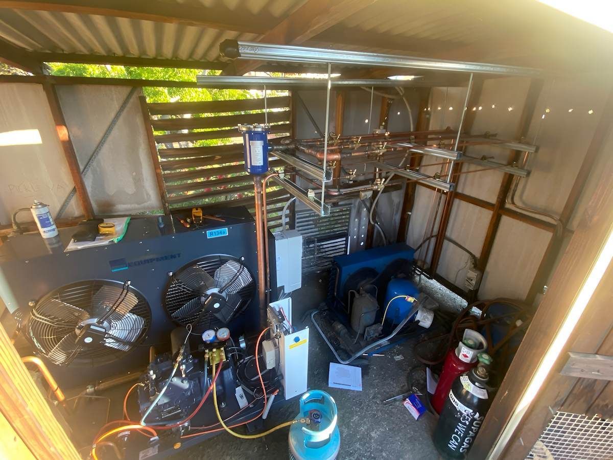 An Outdoor Shed Houses an Air Conditioning Unit — Refrigeration & Air Conditioning in Warners Bay, NSW