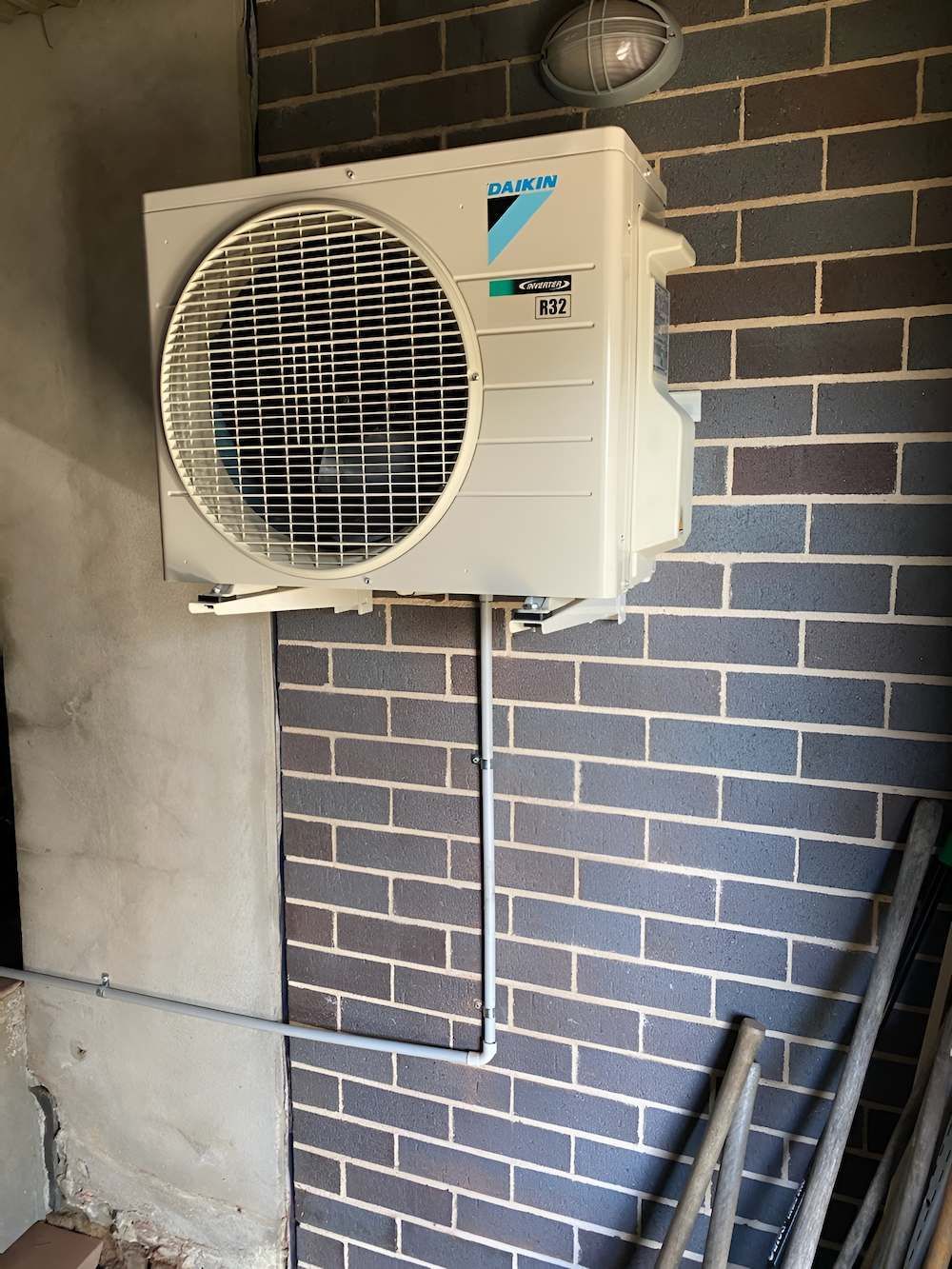 Outdoor Daikin Air Conditioner Mounted on a Brick Wall — Refrigeration & Air Conditioning in Port Stephens, NSW