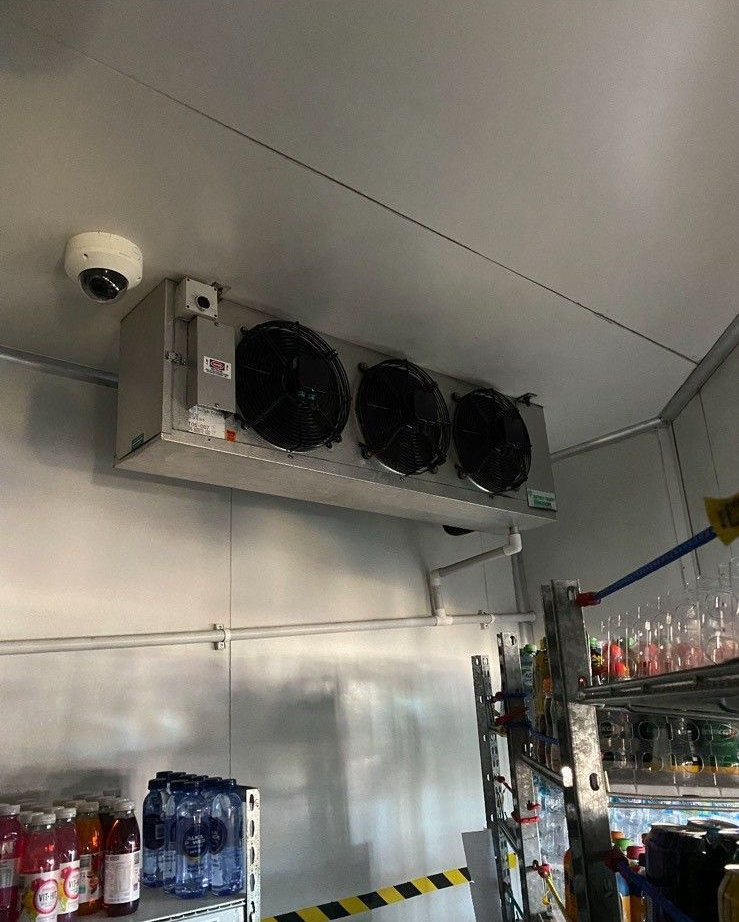 A Refrigerated Space with a Large Cooler Unit with Three Fans Mounted on the Ceiling — Refrigeration & Air Conditioning in Warners Bay, NSW