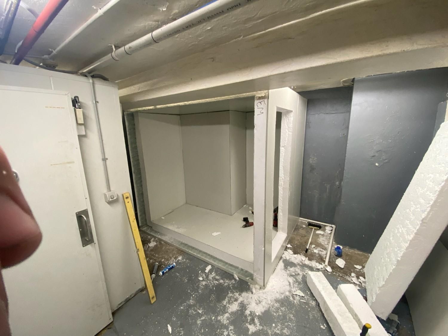 A Small, Unfinished Room with White Walls and Exposed Ceiling Pipes — Refrigeration & Air Conditioning in Jewells, NSW