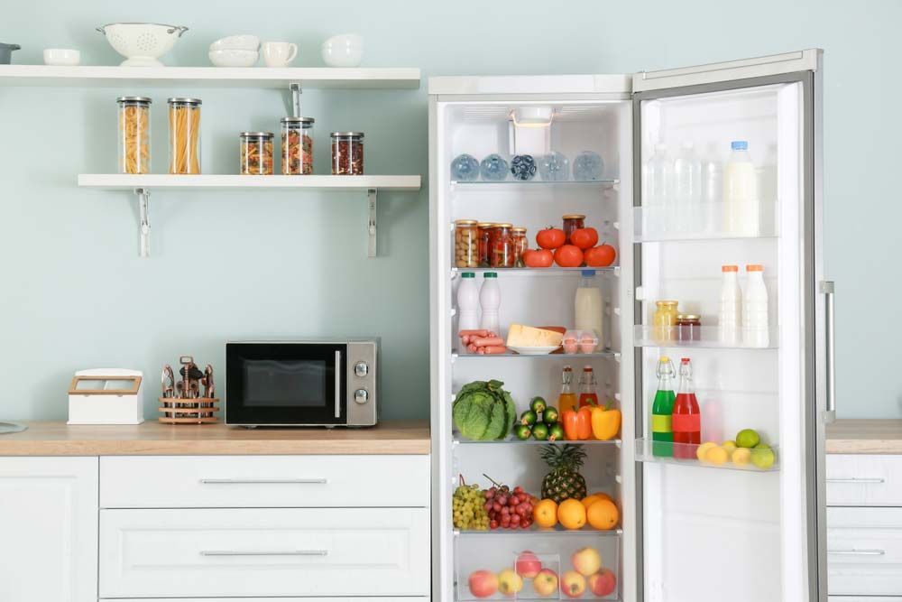 Open Fridge With Foods And Drinks Inside — Refrigeration & Air Conditioning in Newcastle, NSW