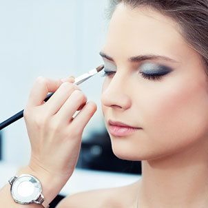 Applying makeup at beauty salon