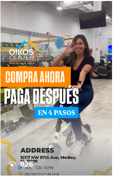 A woman is riding an exercise bike in a gym.