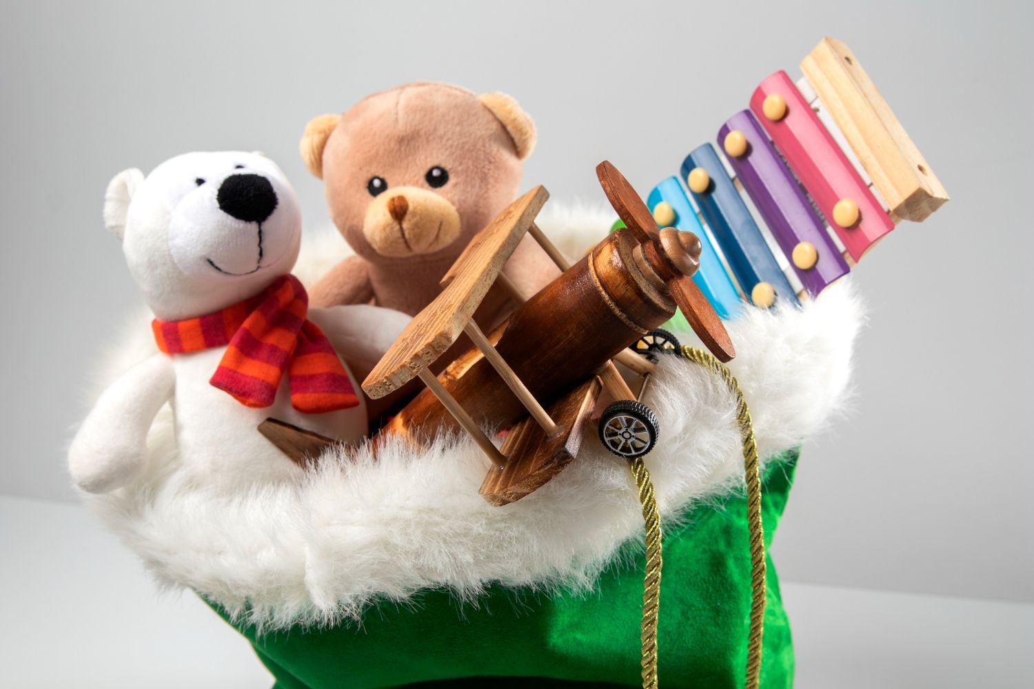 A santa hat filled with stuffed animals and toys