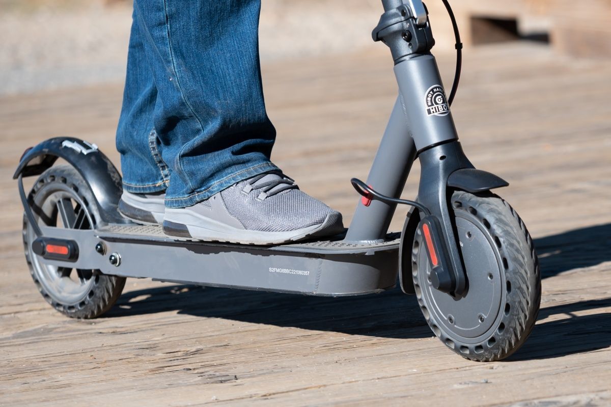 A row of electric scooters are lined up in a store.