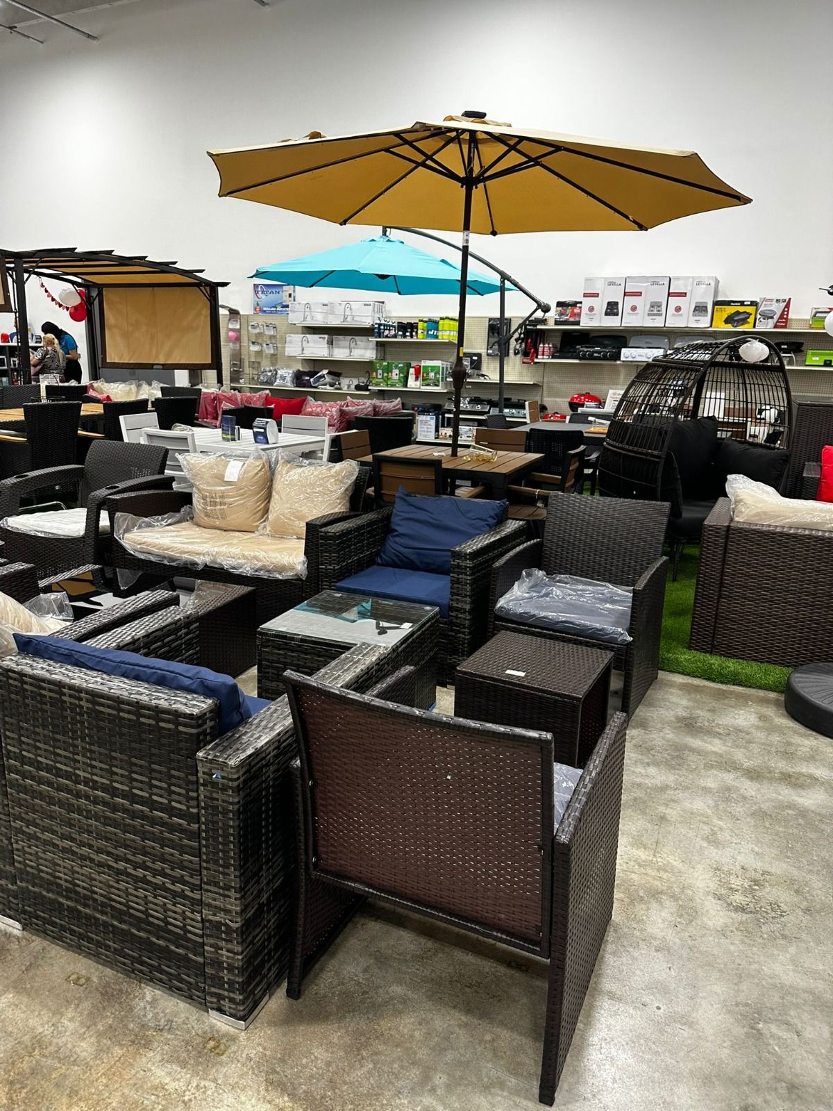 A room filled with furniture and umbrellas in a store.