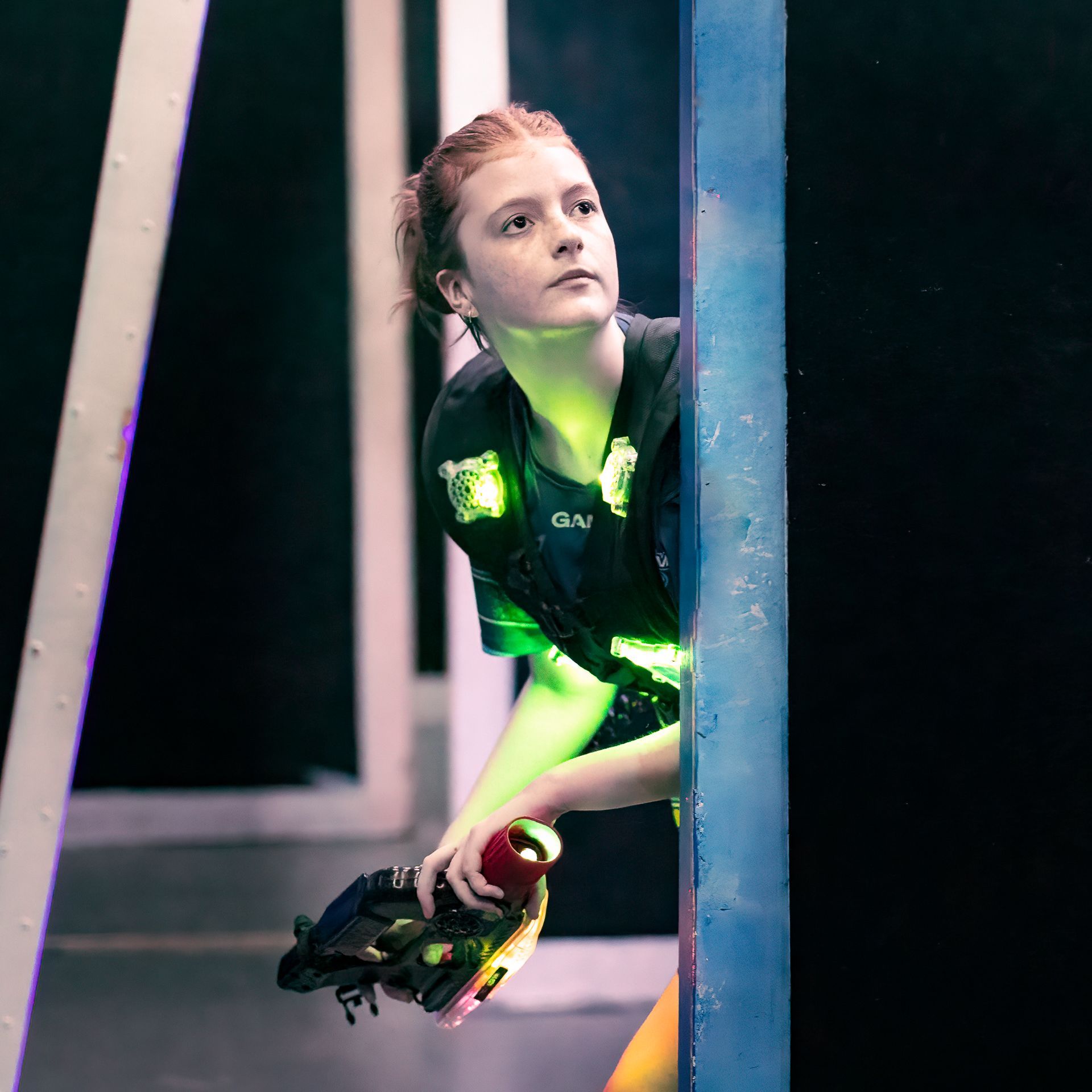 Teenage girl playing competitive laser tag