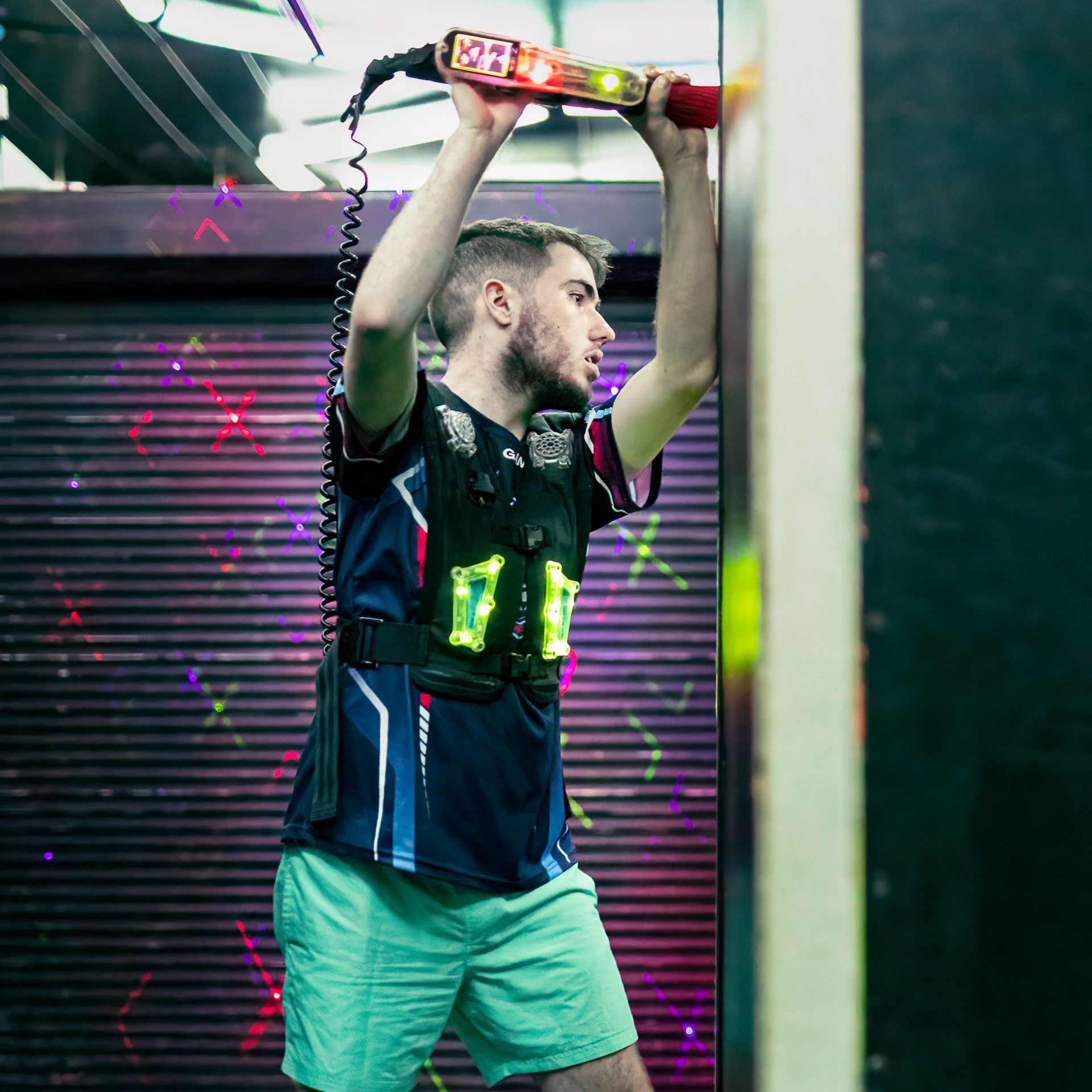 Adult male playing competitive laser tag