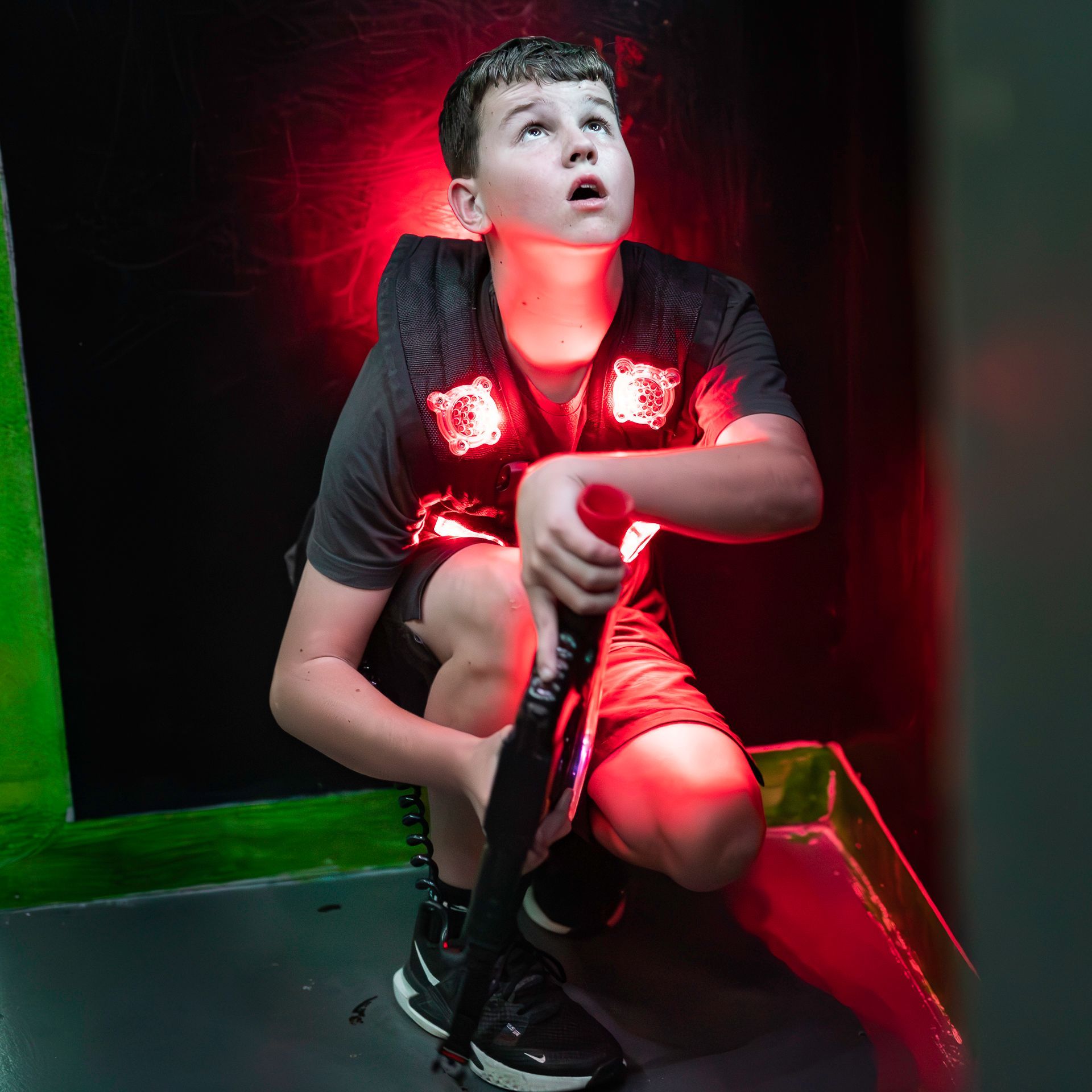 Youth playing competitive laser tag