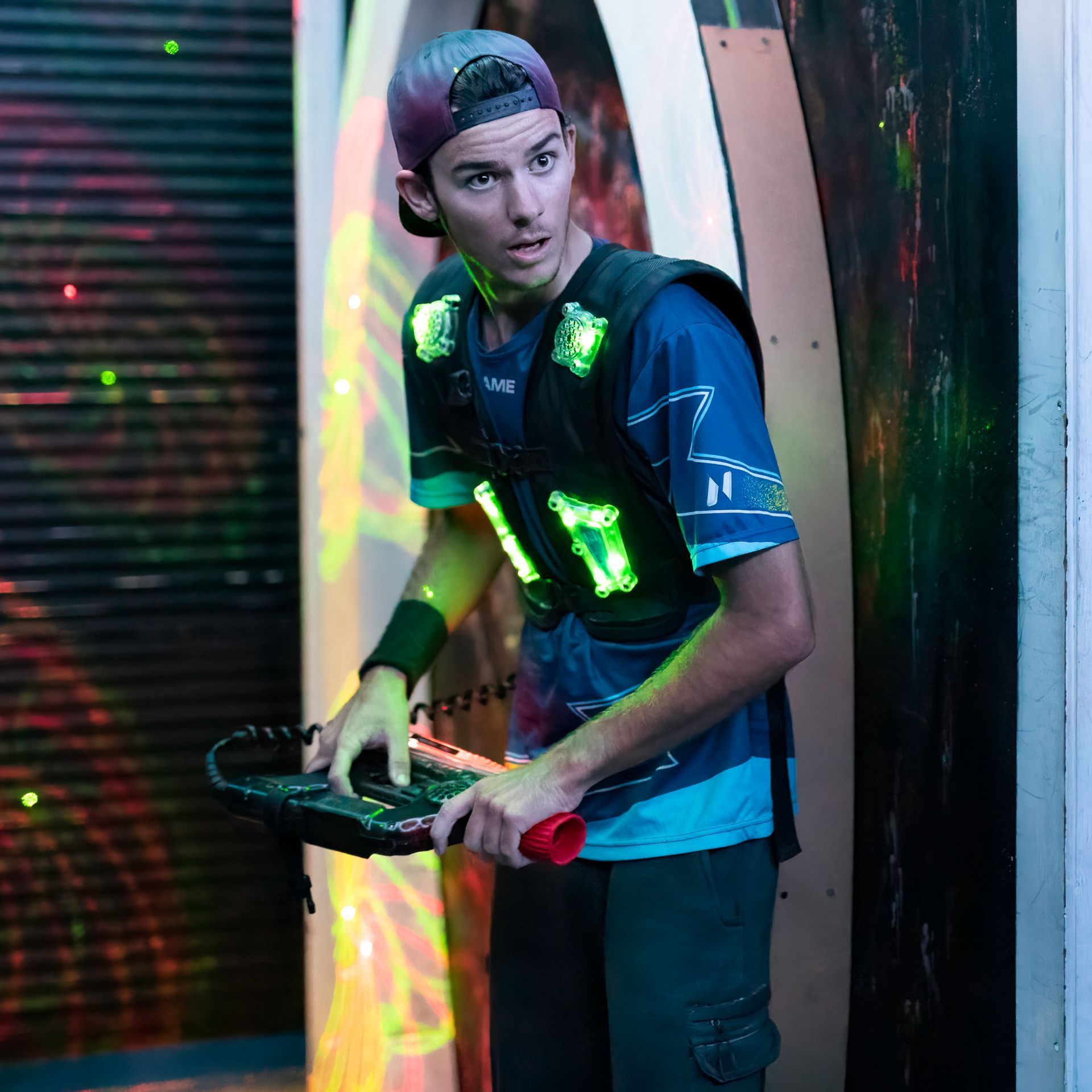 Young adult playing competitive laser tag