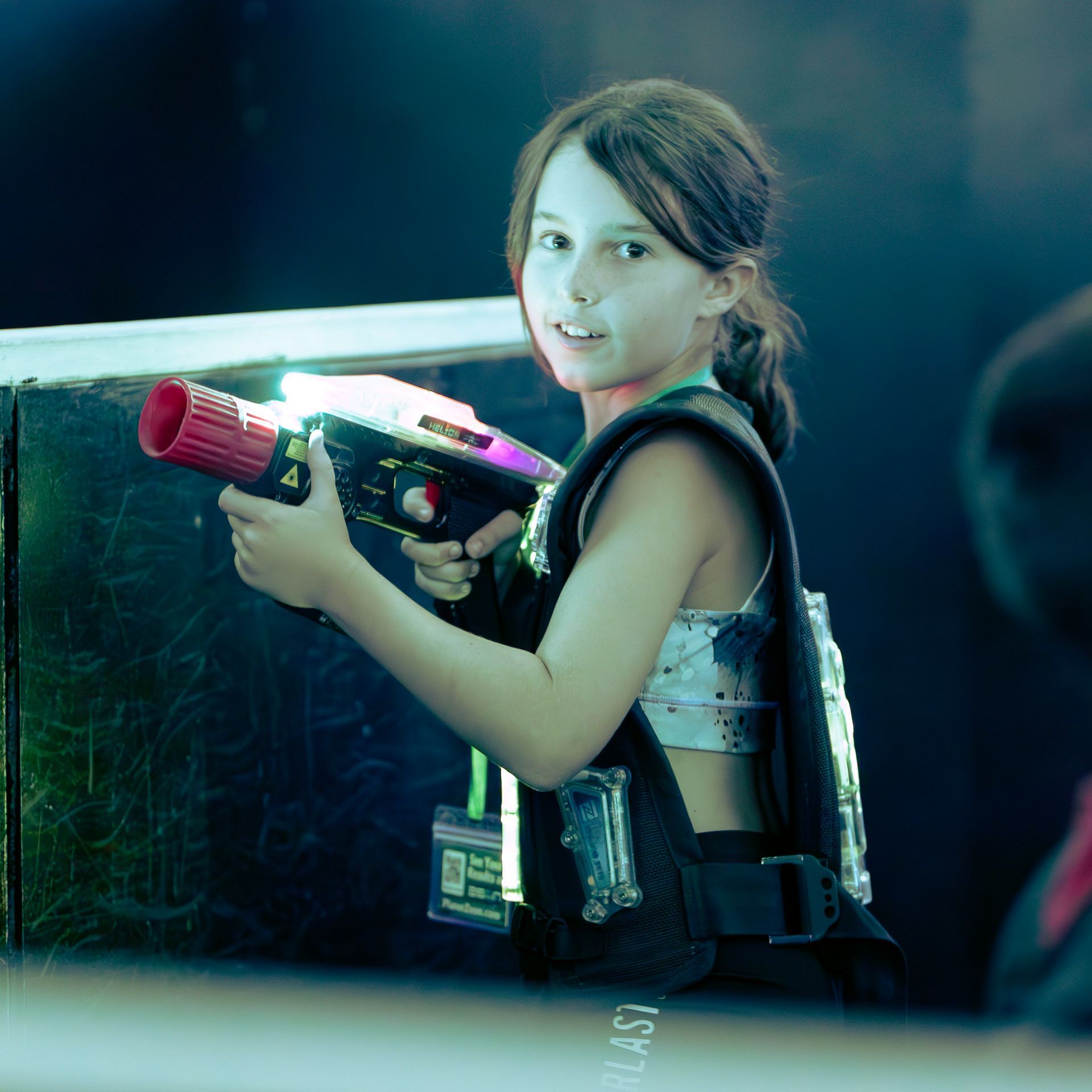 Girl plays competitive laser tag