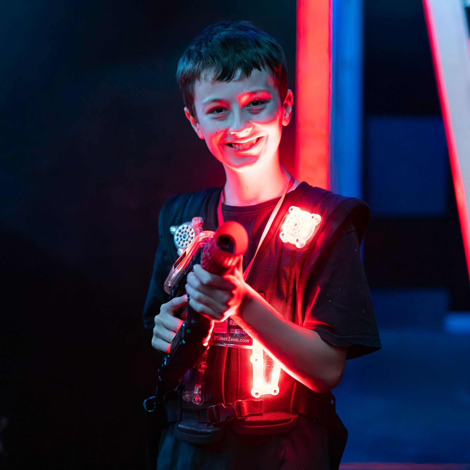 Youth playing competitive laser tag