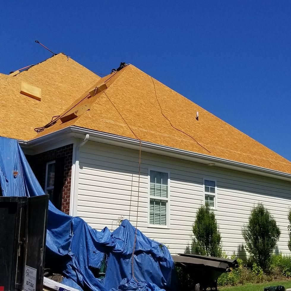 A house with a roof that is being worked on