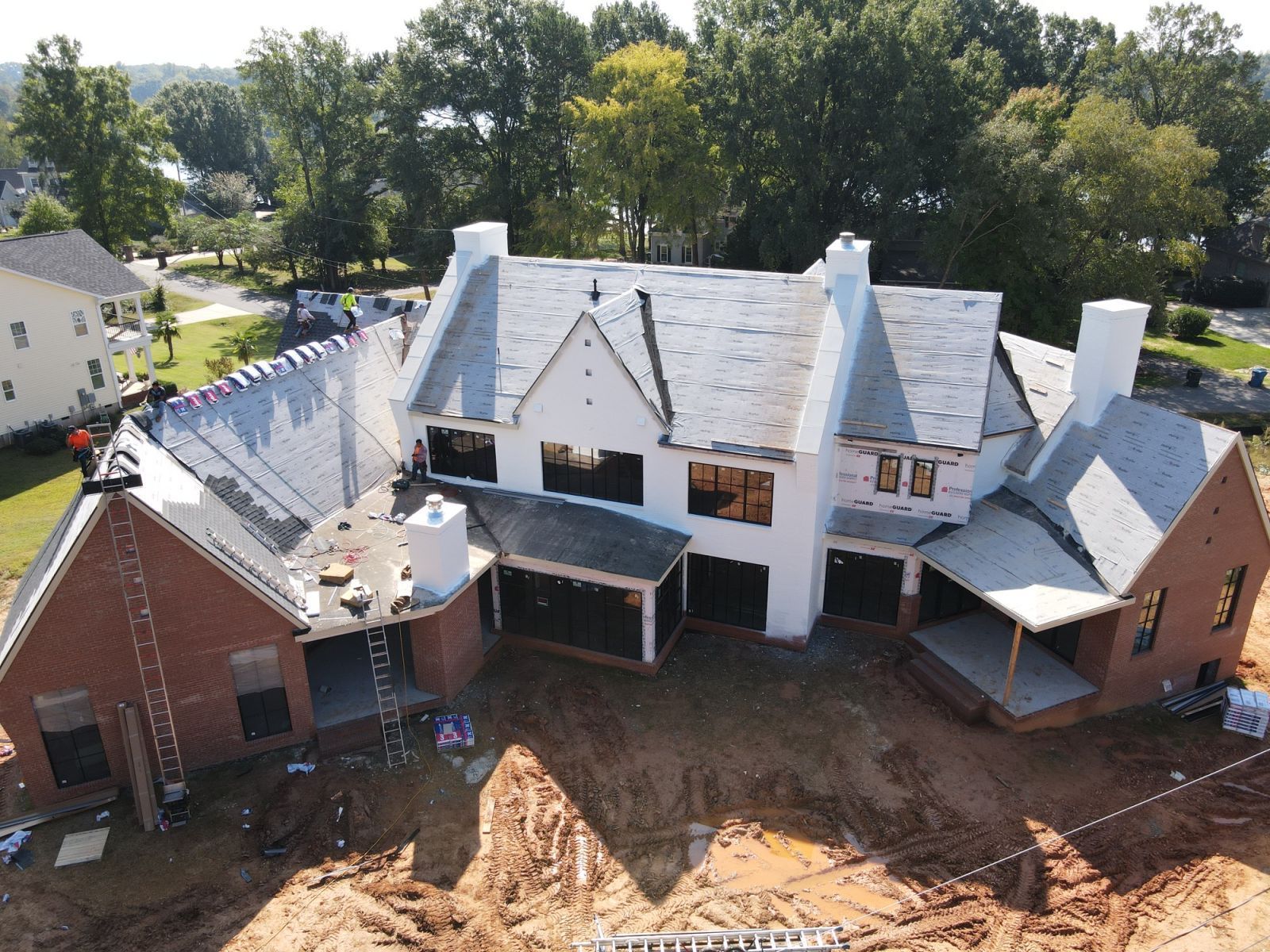 An aerial view of a large house under construction