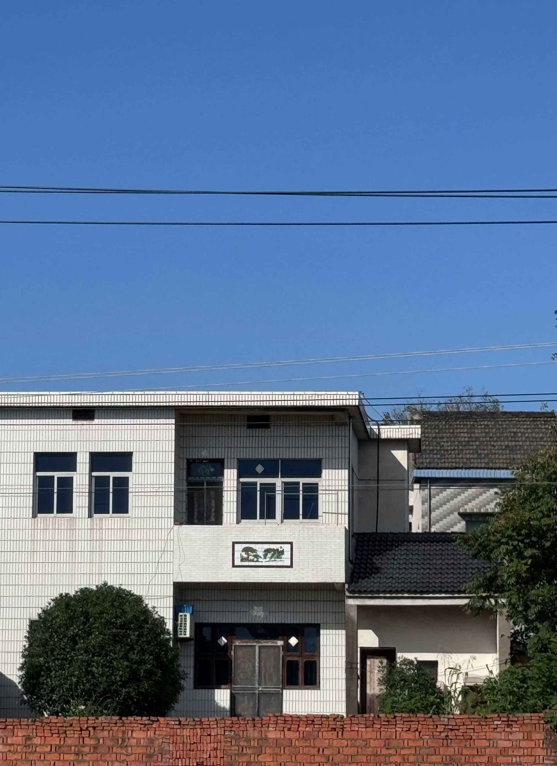 Two men are working on the roof of a house