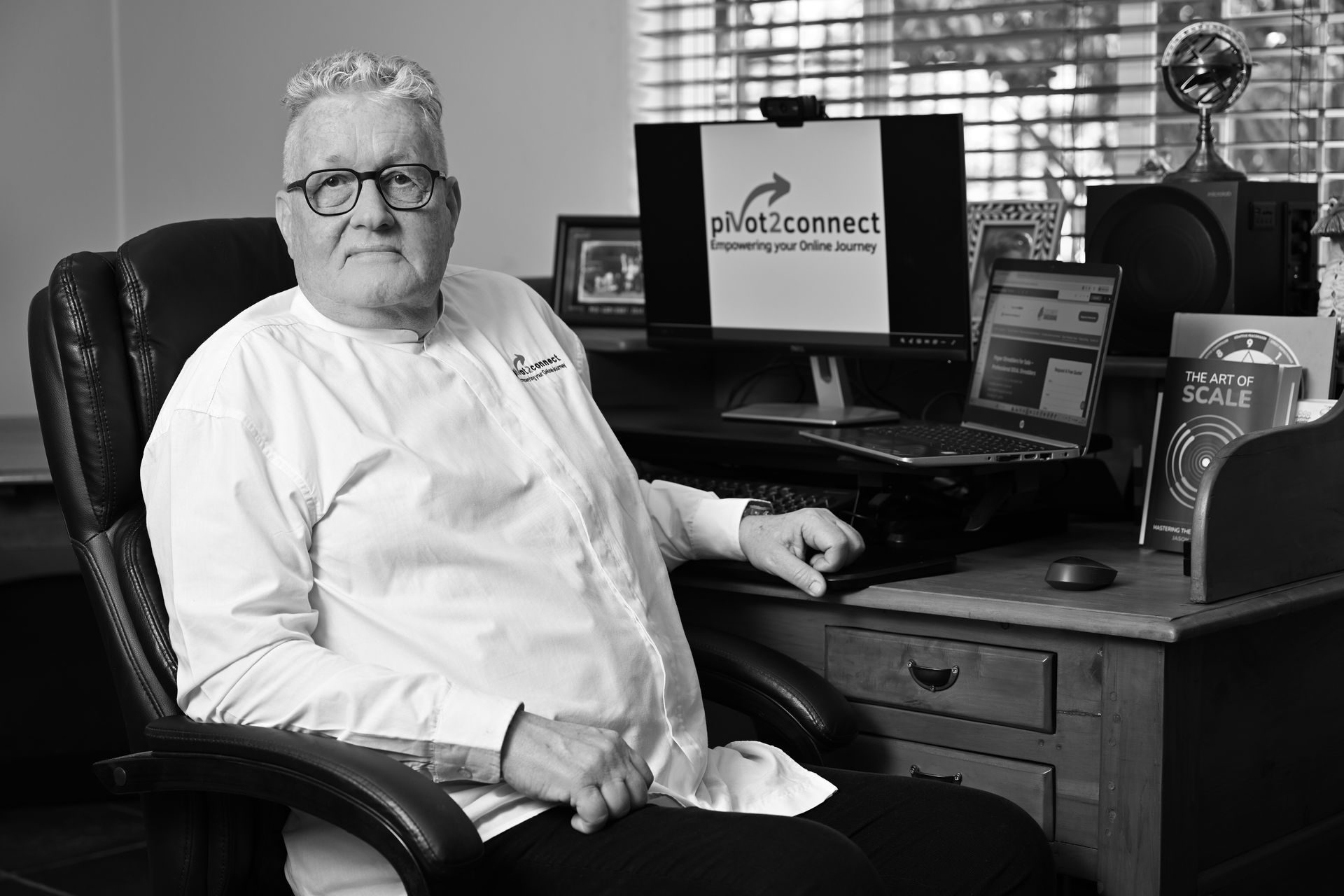 The director of Pivot2Connect sitting at his desk.