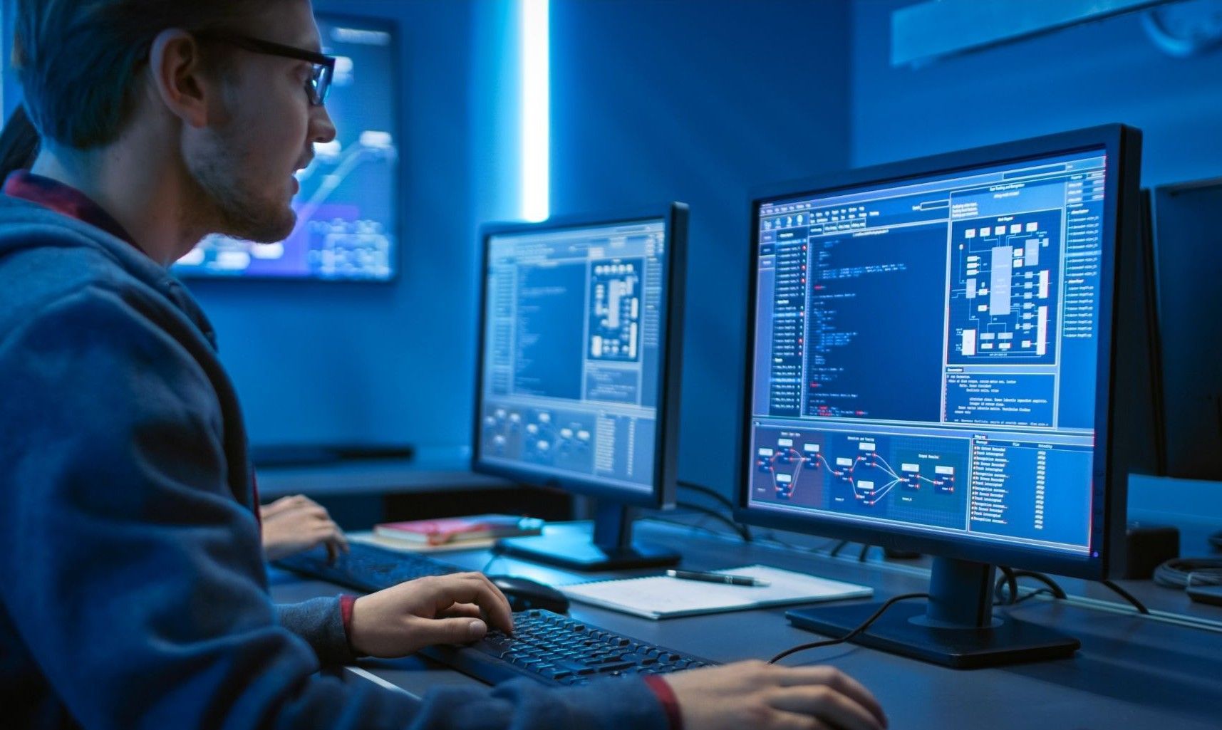 Pivot2Connect website designer at work in front of a display screen.