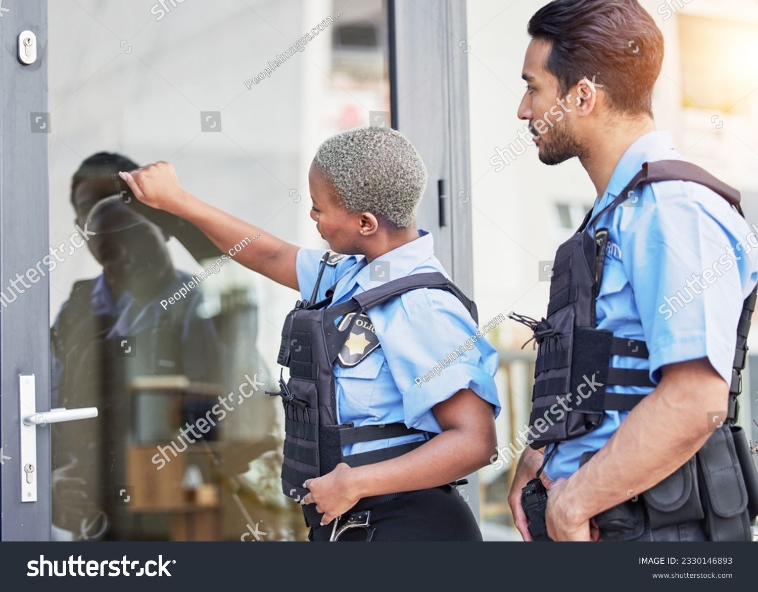 A man and a woman are standing next to each other in front of a door
