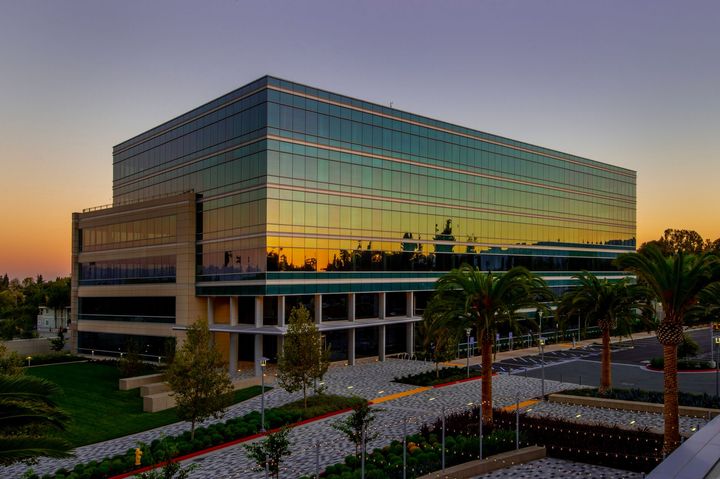 An Aerial View of a Large Glass Building with a Sunset in the Background — Tucson, AZ — Ochoa Landscaping, Inc.