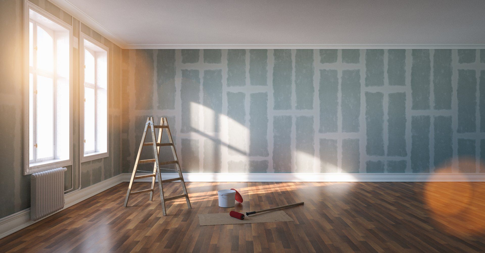 An empty room with a ladder and tools on the floor.