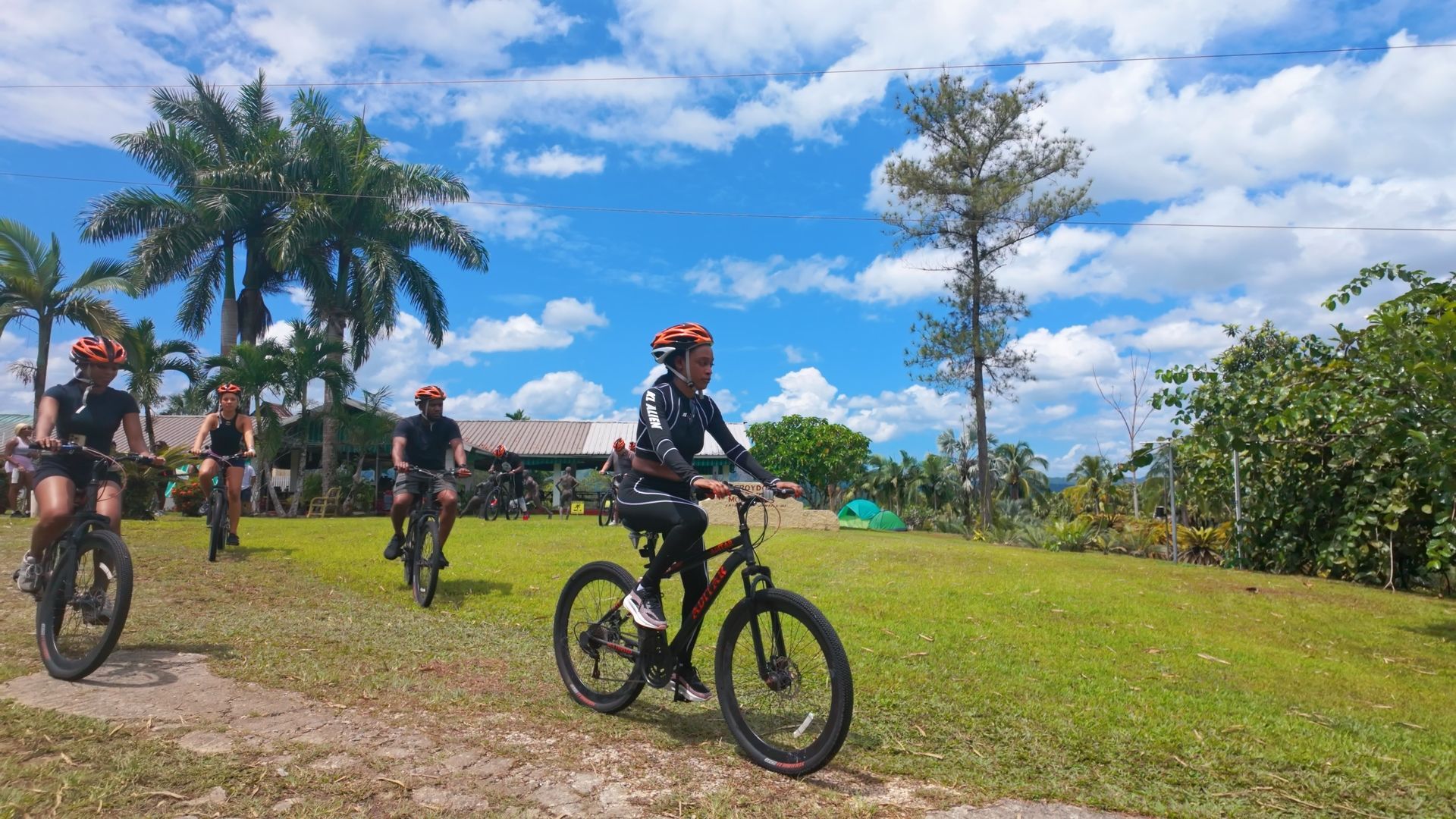 A group of people are riding bicycles on a dirt road.