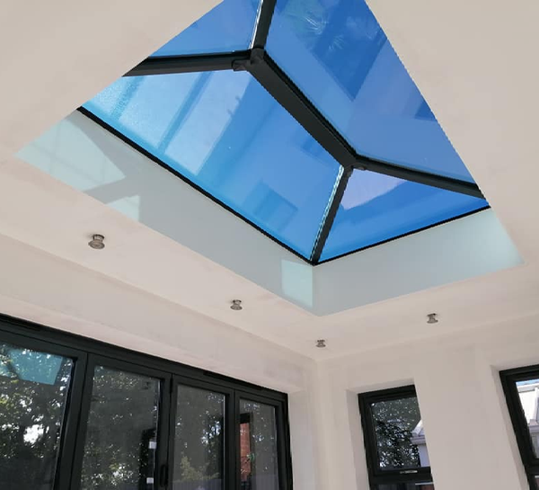 looking up at a blue skylight in a room