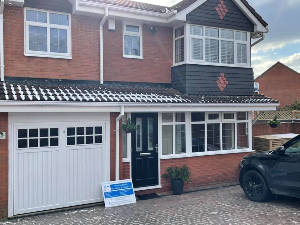 a car is parked in front of a brick house .