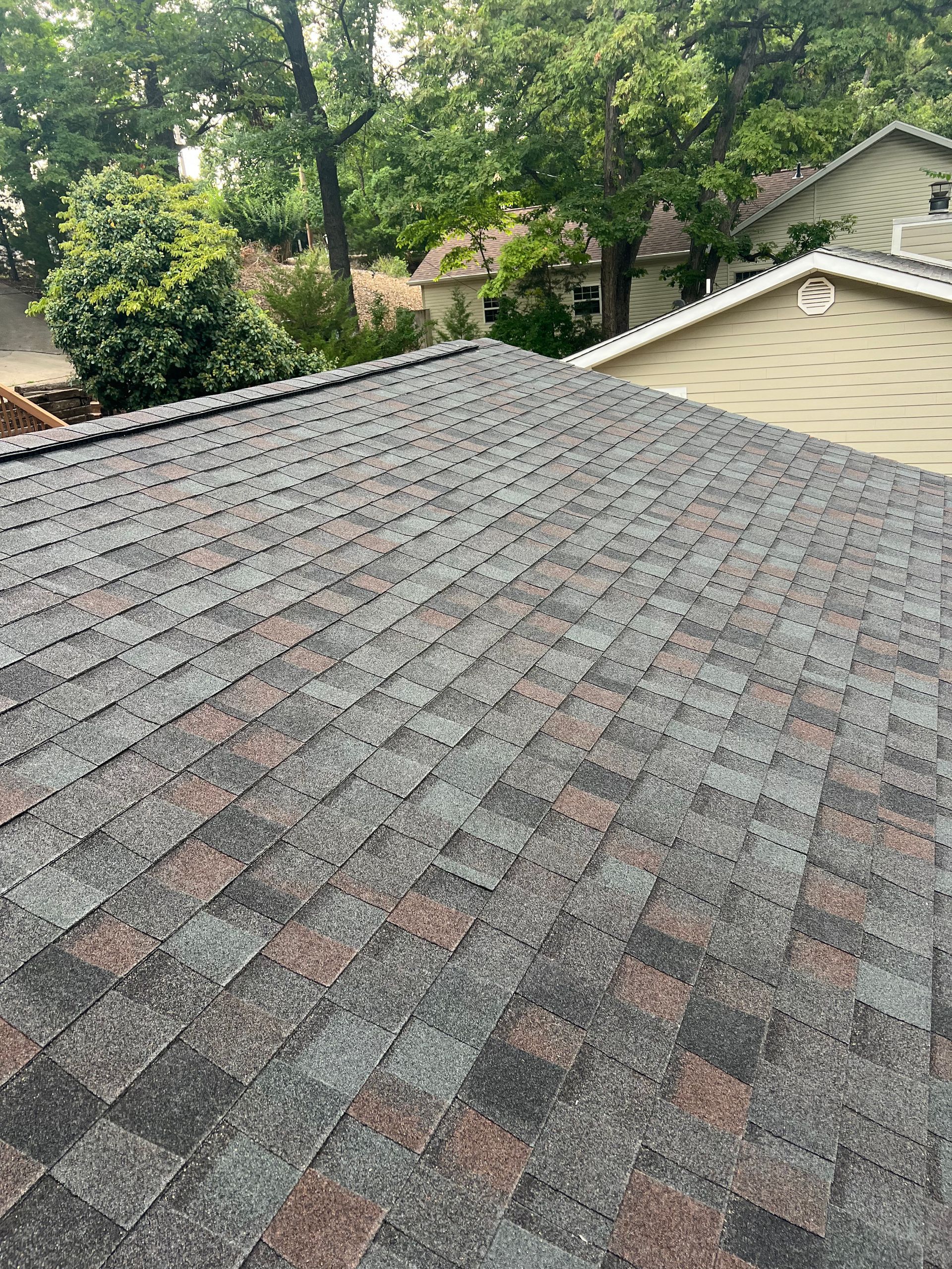 Dark gray and brown asphalt shingle roof.