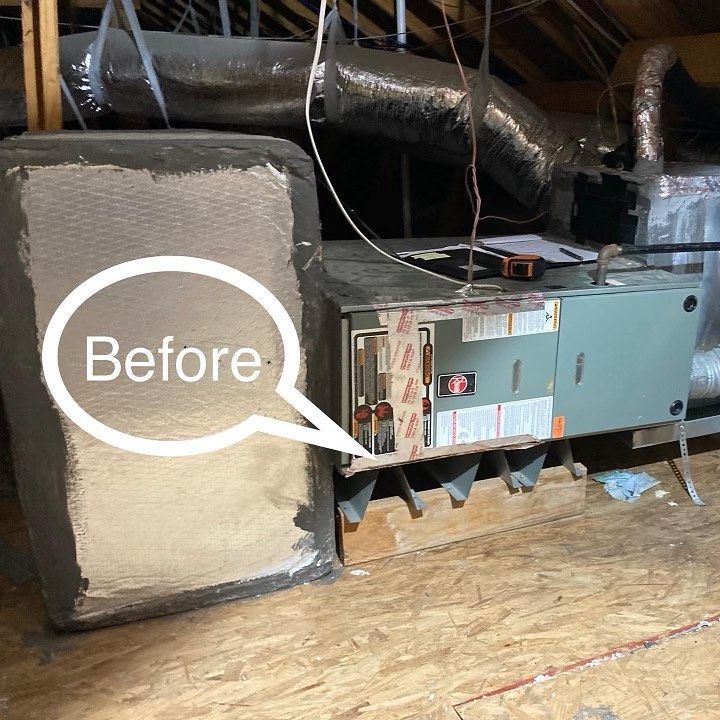 HVAC unit in an attic with insulated box labeled 