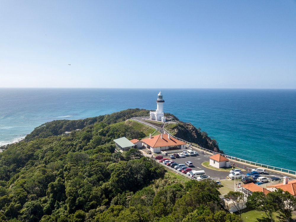 An Aerial View Of A Lighthouse On Top Of A Hill Overlooking The Ocean — JC Coastal Construction In Byron Bay, NSW