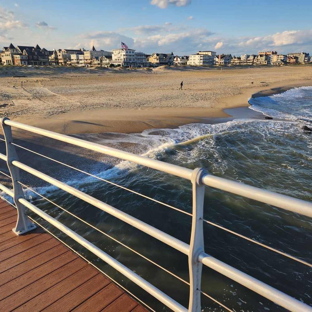 A View Of A Beach From A Pier With A White Railing — JC Coastal Construction In Ocean Shores, NSW