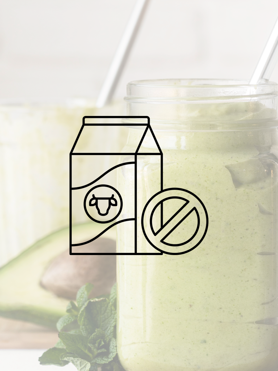 An avocado smoothie with a carton of milk and a straw