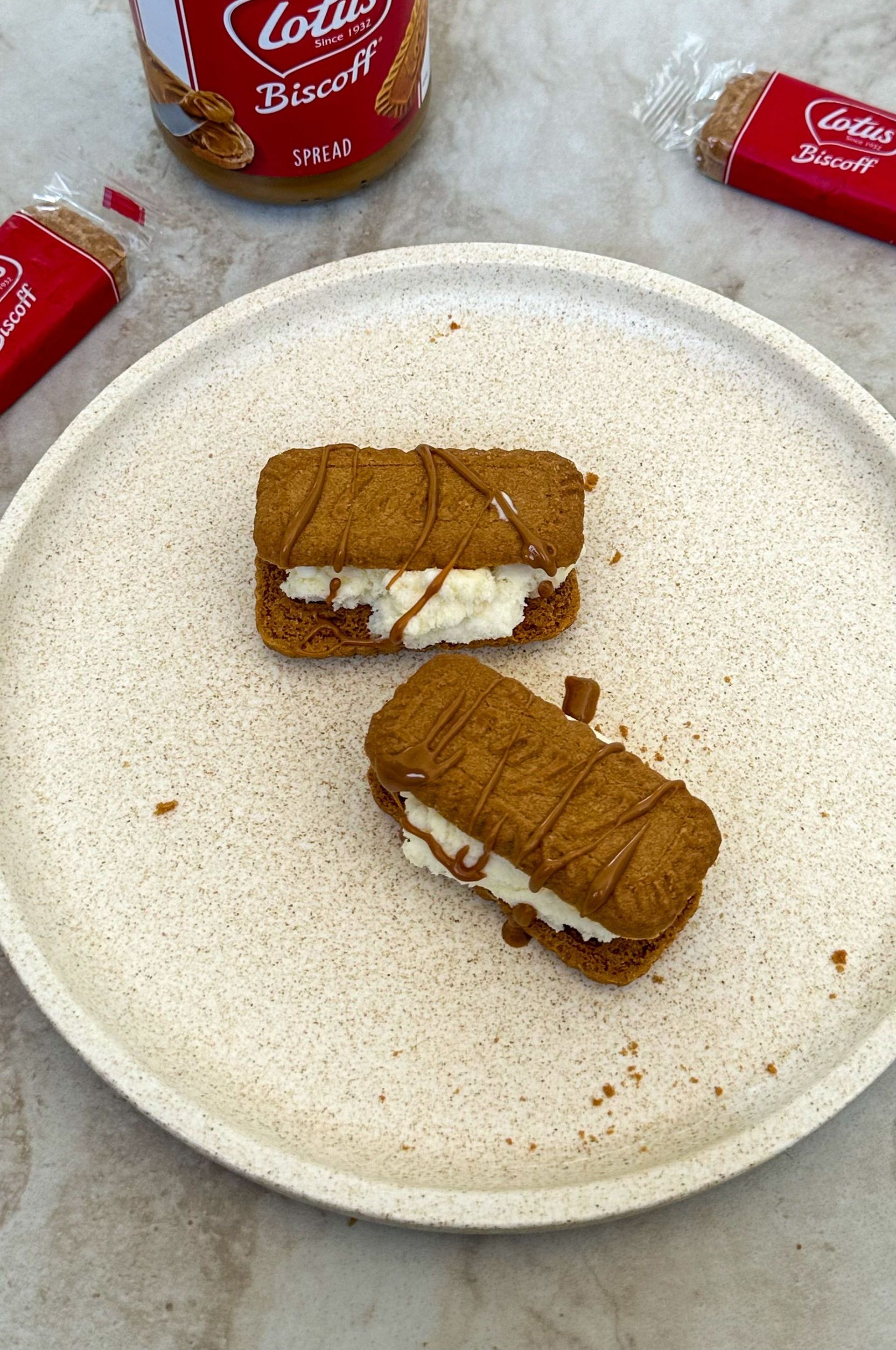 Two lotus biscuit sandwiches are on a white plate.