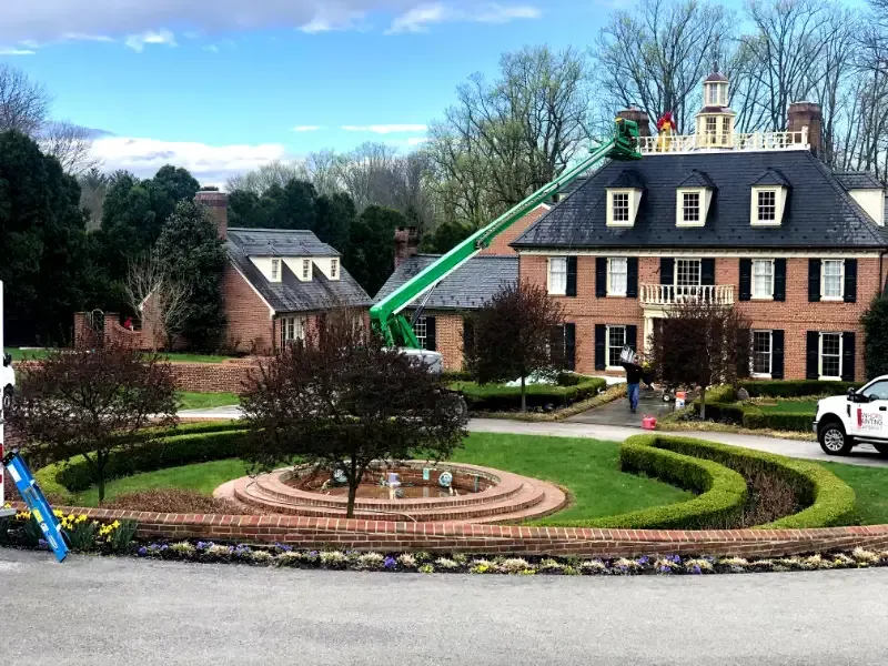 A large brick house with a white truck parked in front of it