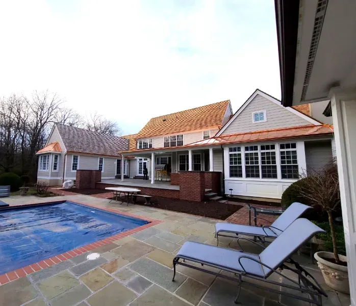 A large house with a swimming pool in front of it