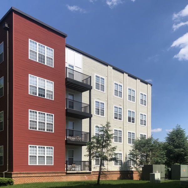 A red and white apartment building with many windows