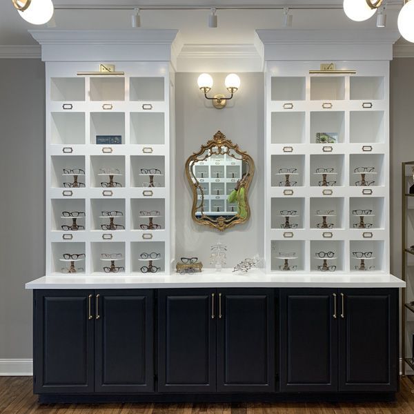 A room with a lot of shelves and a mirror