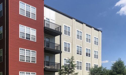 A large apartment building with a lot of windows and balconies.