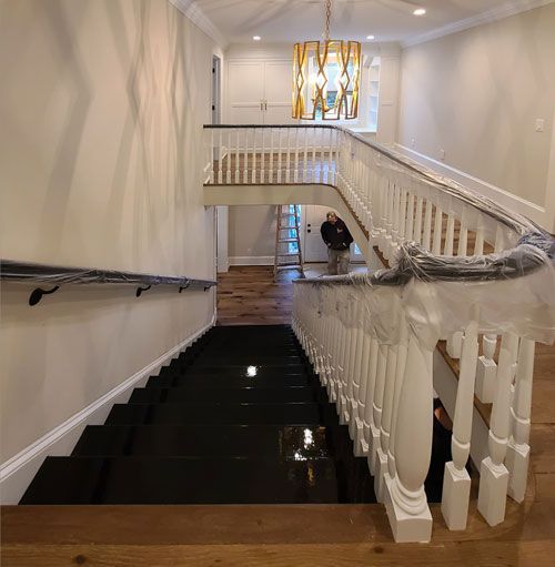 A man is walking down a set of stairs in a house