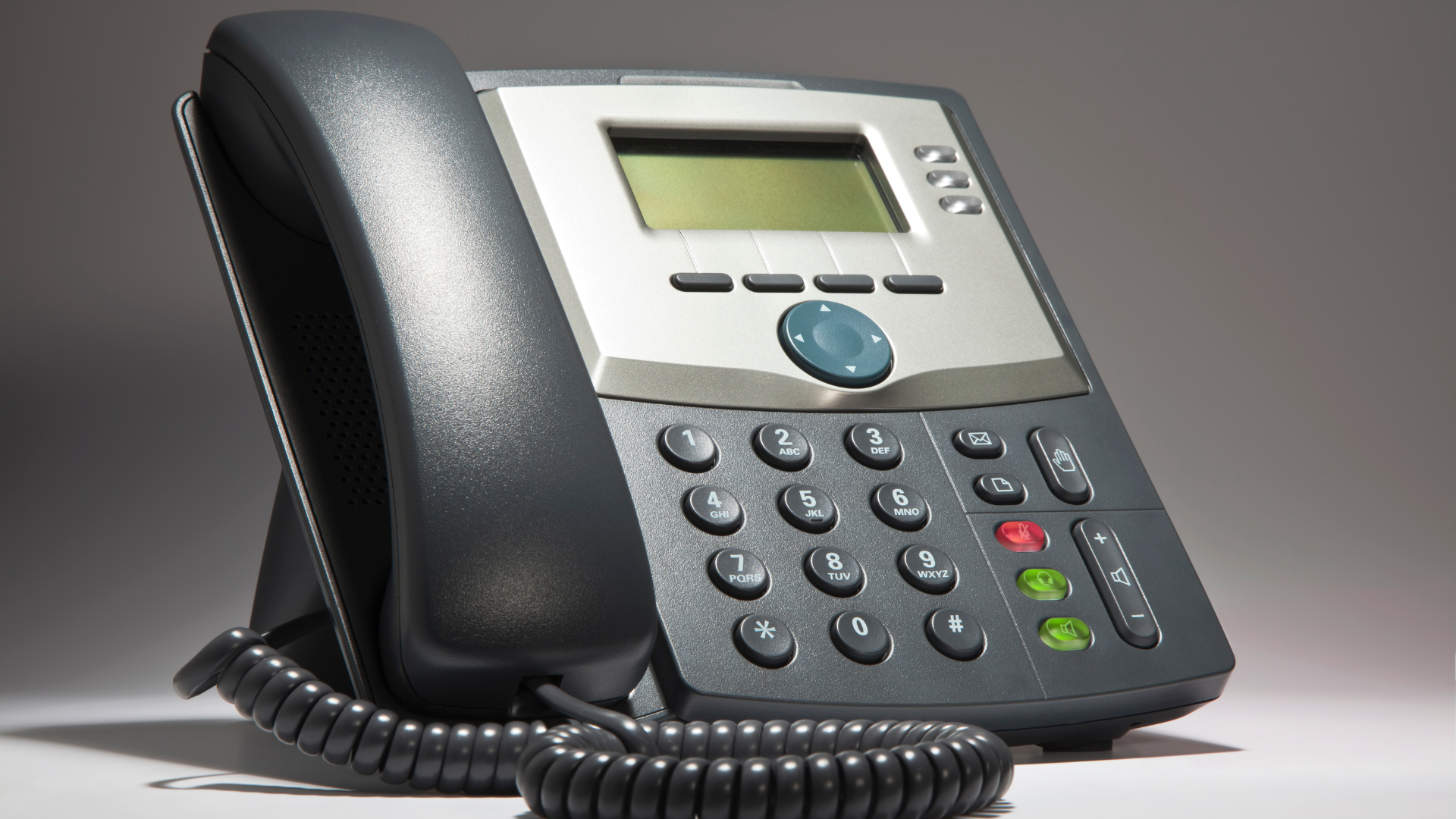 A black telephone with a screen that says ' cisco ' on it