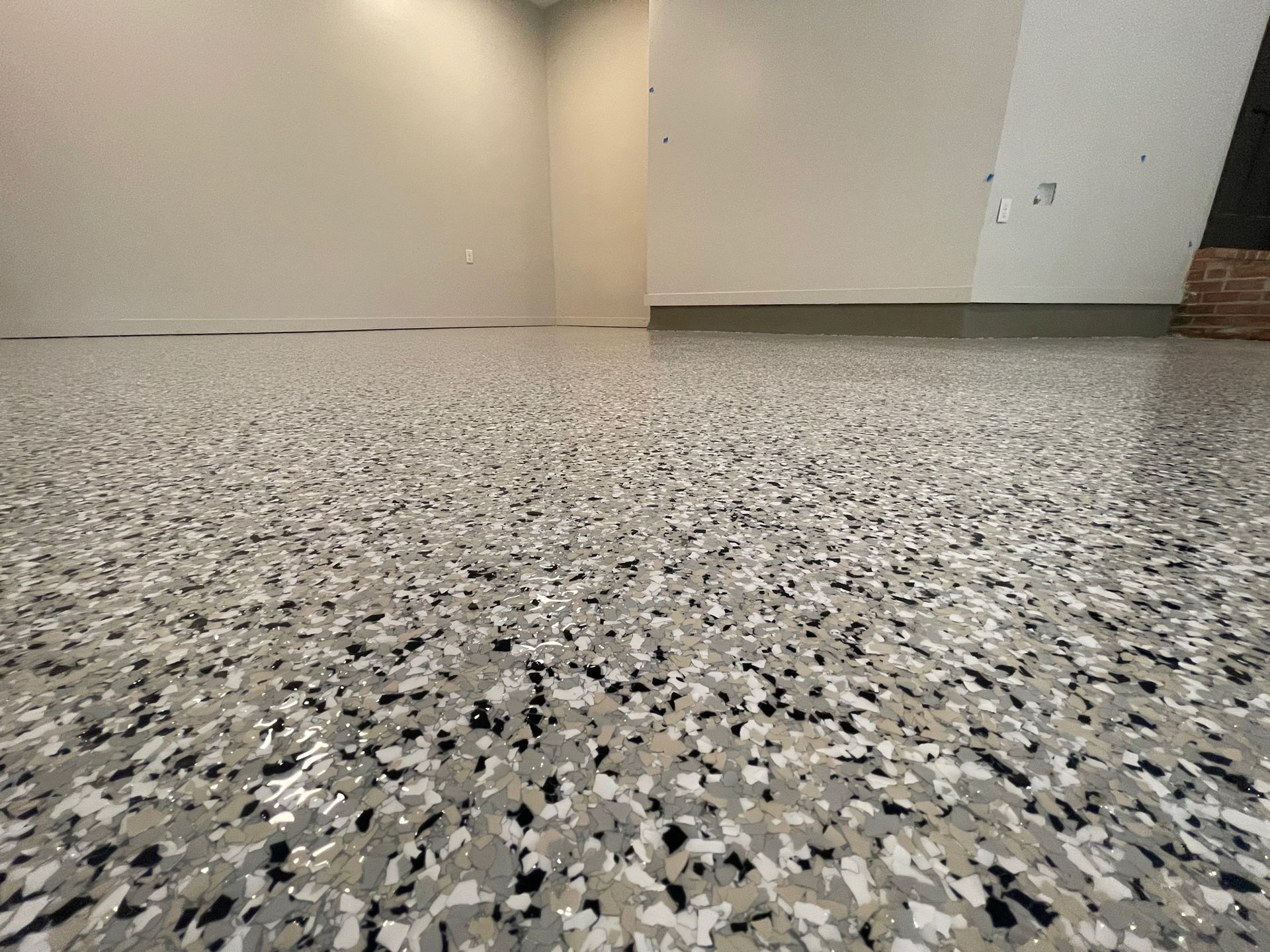 A close up of a gray and black floor in a room.